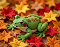 フェルトの落ち葉の上で、お昼寝するもこもこガマ - A fluffy frog taking a nap on a pile of fallen felt leaves
